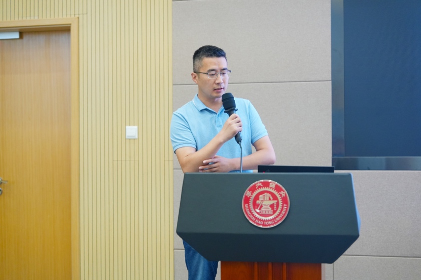 A person standing at a podium speaking into a microphone
Description automatically generated