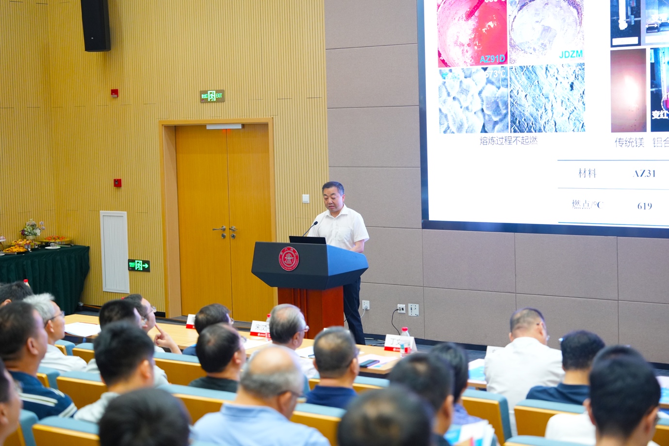 A person standing at a podium giving a presentation
Description automatically generated